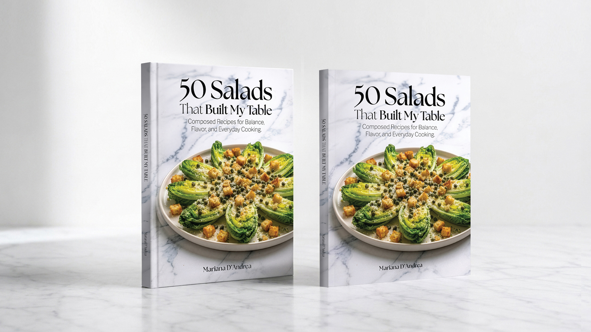50 Salads That Built My Table — Paperback and Hardcover editions standing side by side